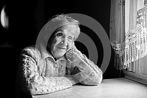 Black and white contrast portrait of an elderly happy woman.