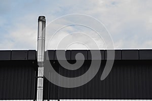 Black and white Corrugated metal sheet texture surface on a building wall with a cloudy sky. Galvanize steel background.