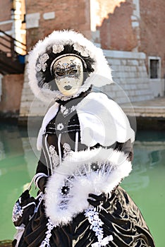 Black and white costumed masked woman