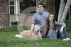 Black and white couple in front of new home