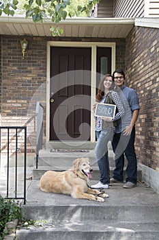 Black and white couple in front of new home