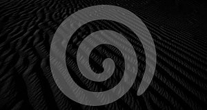 Black and white dark texture of desert sand dunes