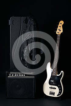 Black and white electric bass guitar with amplifier