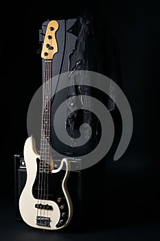 Black and white electric bass guitar with amplifier