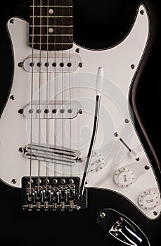 Black and white electronic guitar close up view