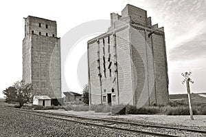 (Black and White) Extremely old grain elevators, poured and block