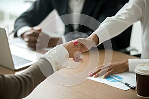 Black and white female hands shaking at group meeting, closeup