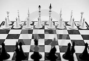 Black and white figures on a chessboard
