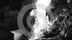 Black and white footage of a burning electric guitar. The atmosphere of the Apocalypse.