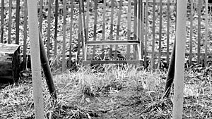 Black and white footage shot of deserted old abandoned ghetto playground swings. video stylized as old movie