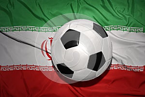 Black and white football ball on the national flag of iran