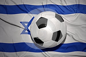 Black and white football ball on the national flag of israel