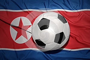 Black and white football ball on the national flag of north korea