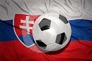 Black and white football ball on the national flag of slovakia