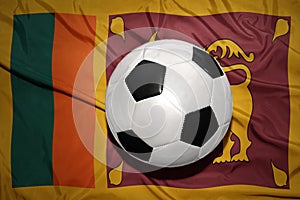 Black and white football ball on the national flag of sri lanka