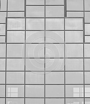 Black and white fragment of a modern office building. Abstract geometric background. Part of the facade of a skyscraper