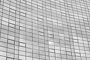 Black and white fragment of a modern office building. Abstract geometric background. Part of the facade of a skyscraper