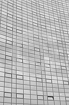 Black and white fragment of a modern office building. Abstract geometric background. Part of the facade of a skyscraper