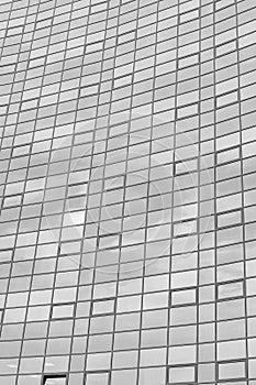 Black and white fragment of a modern office building. Abstract geometric background. Part of the facade of a skyscraper