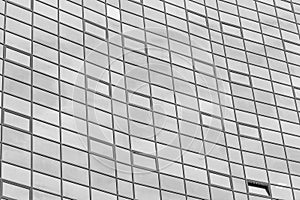 Black and white fragment of a modern office building. Abstract geometric background. Part of the facade of a skyscraper
