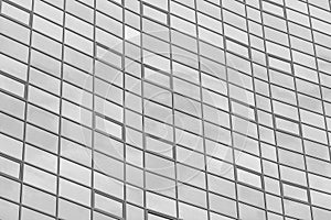 Black and white fragment of a modern office building. Abstract geometric background. Part of the facade of a skyscraper