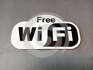 Black and white free WIFI icon isolated on a grey background.