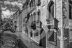 Black and white glimpse of the San Marco district on the Rio dei Barcaroli near the Frezzaria swimming pool, Venice, Italy