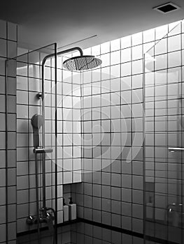 Black and white grid tiles wall, the interior of modern shower space box in the bathroom.