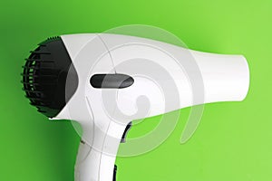 Black and white hair drier on a green background