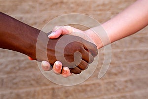 Black and White Hands Grasped in Unity