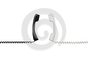 Black and white handsets are arranged vertically towards each other