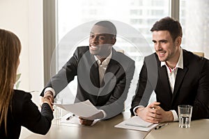 Black and white hr recruiters welcoming applicant on job intervi