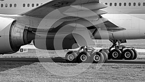 Black and white image of A7-BAI Undercarriage on the 777-3DZ - stock photo