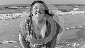 Black and white image of a beautiful latin woman wearing casual clothes enjoying a wonderful day on the beach