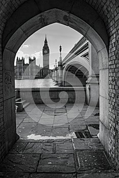 Black and white image of the Big Ben and Houses of parliament from a narrow tunnel