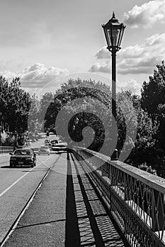 Black and white image of bridge with old fashioned lamp posts