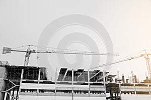 Black and white image of building crane and buildings under construction