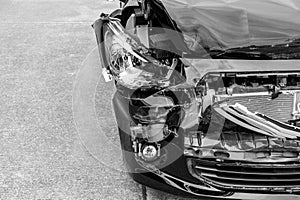 Black and white image concept, car crash accident on street, damaged automobiles after collision in city.