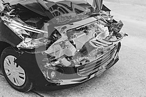 Black and white image concept, car crash accident on street, damaged automobiles after collision in city.