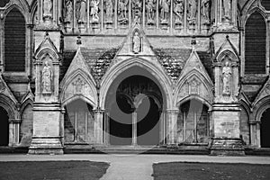 A black and white image of the entrance of Salisbury Cathedral, England.