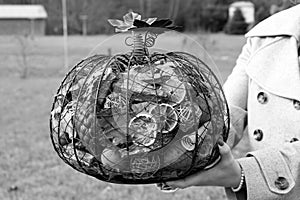 Black and white image of filled metal pumpkin