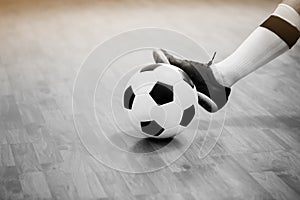 Black and white image of Futsal ball with motion blurry futsal player run and contol ball to shoot  to goal