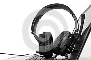Black and white image, headphone on laptop computer