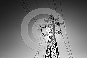 Black and white image with a high voltage electrical pole
