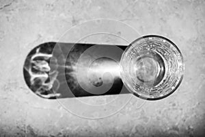 Black and white image of light going through a glass of soda