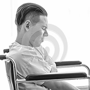 Black white image, Male patient sitting on wheelchair in hospital room