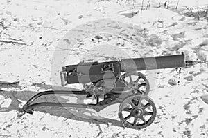 Black and white image of Maxim machine gun with wheels on the firing position