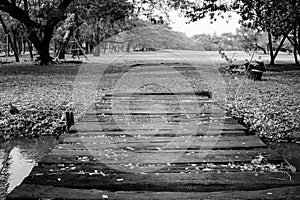 Black and White image of old wooden bridge cross over the river.