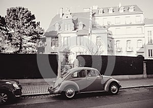 Black and white image of a vintage Volkswagen Beetle car on the