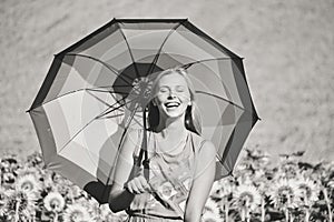 Black and white image of woman with umbrella